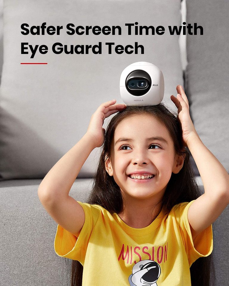 A girl wearing a yellow Mission shirt smiles and puts a Nebula Astro portable projector on top of her head.